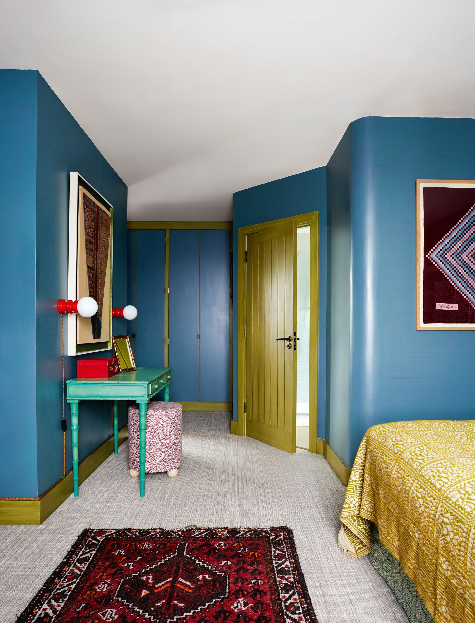 The colour of the Italian bedcover in the spare bedroom is repeated on the woodwork which like the walls has been glazed...