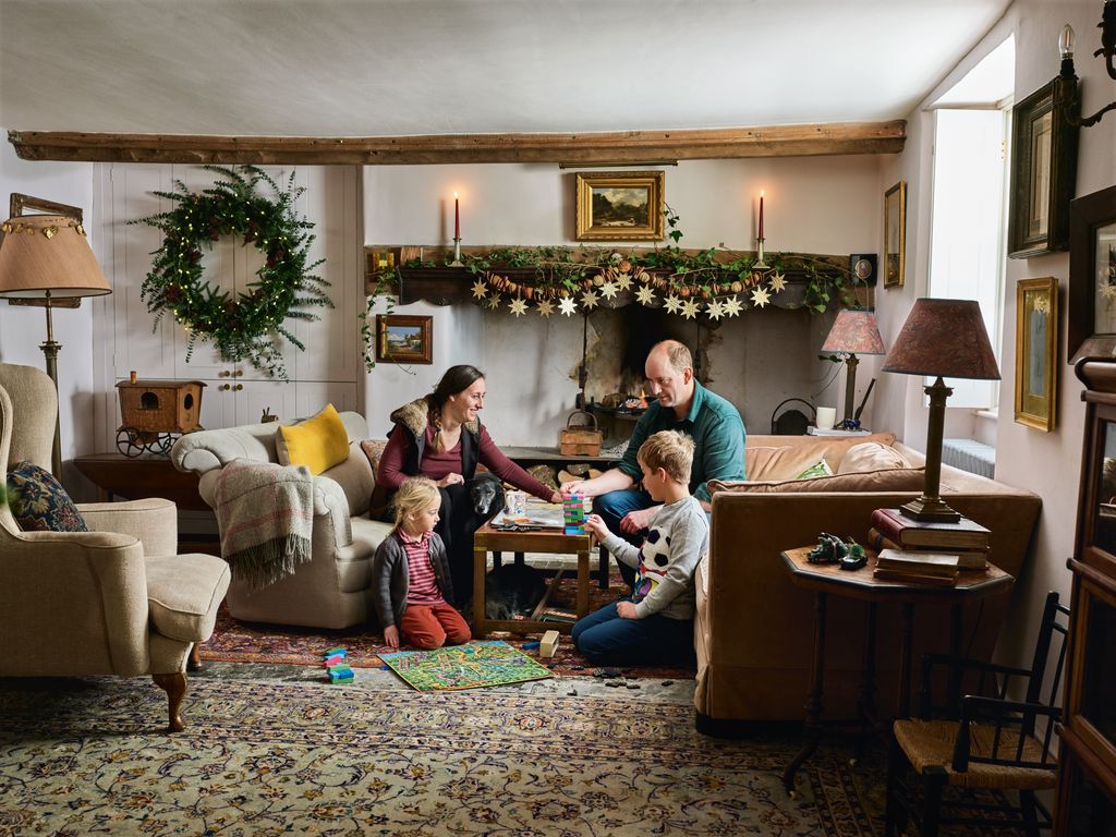 Alex and Anneke with Coco and Freddie in the sitting room adorned with locally gathered greenery. ‘We go allout with...