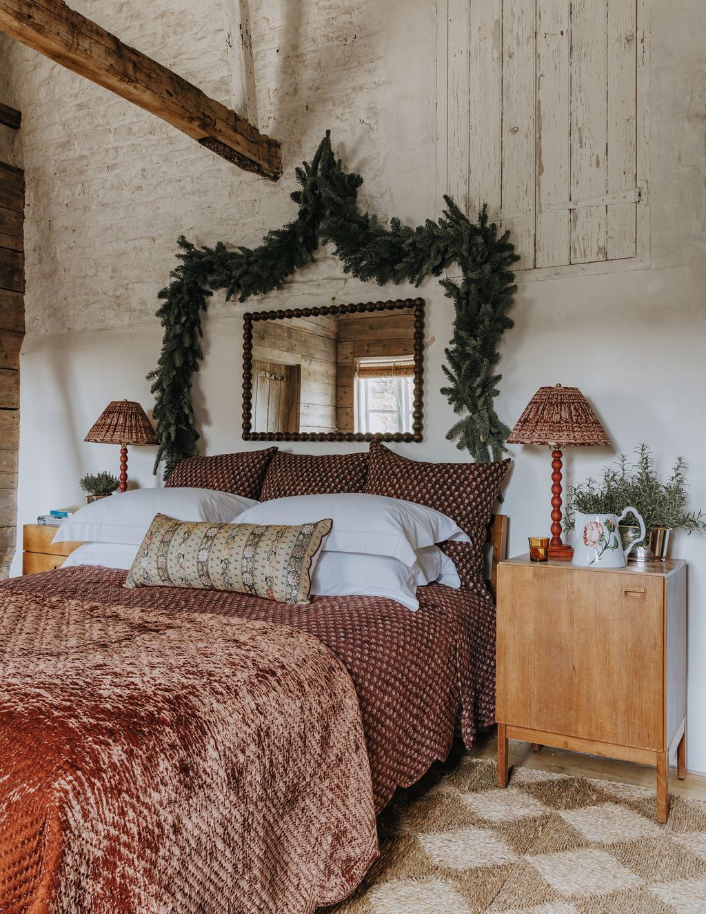 We adore the way that swags of foliage have been used to create the illusion of a headboard in Amanda Brooks' guest...