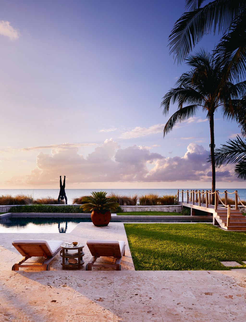 A pair of loungers from Janus et Cie provides the perfect place from which to admire the distinctive bronze sculpture by...