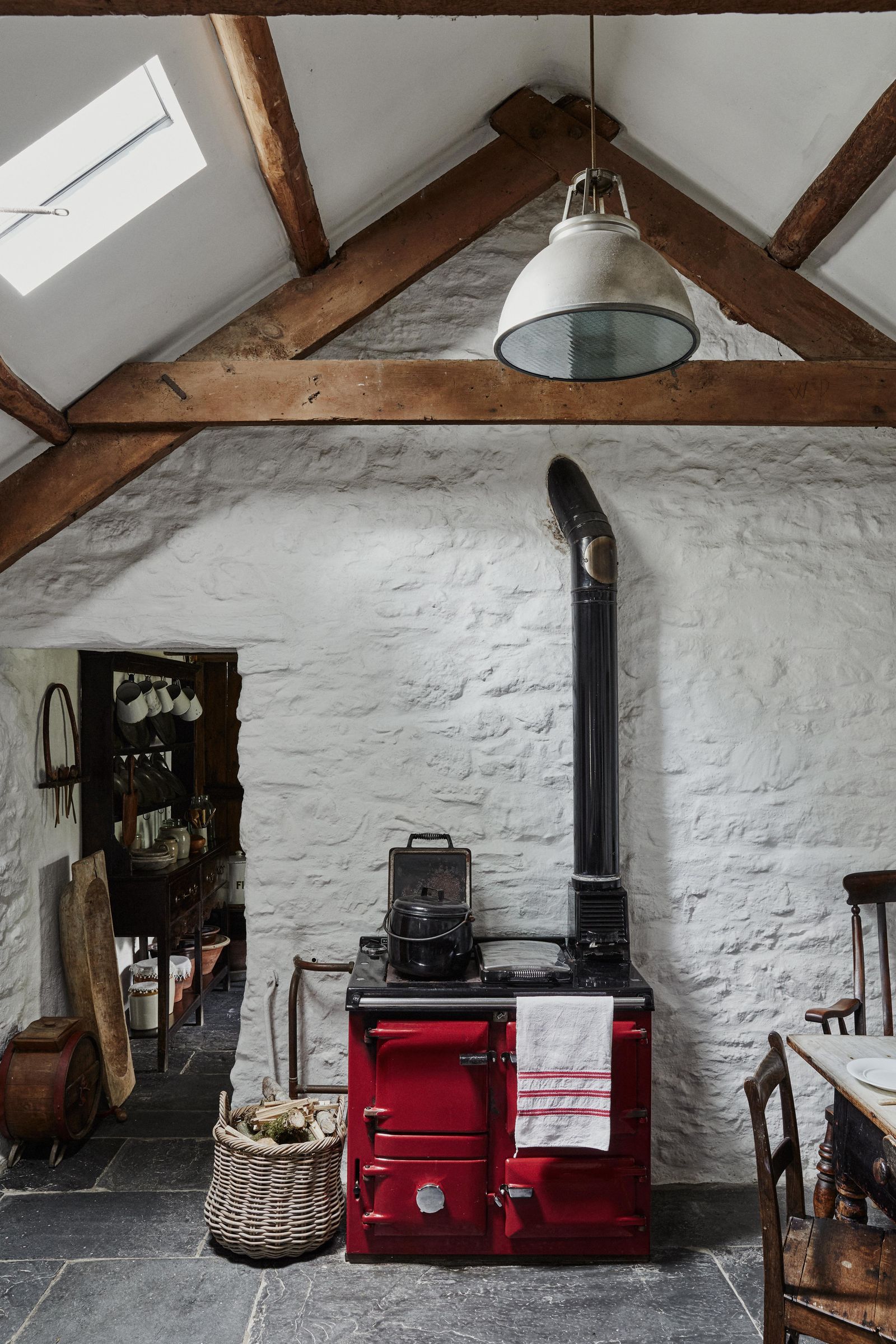 The former cowshed houses the new kitchen. The red cooker is a practical and jolly modern addition and is tapped into...