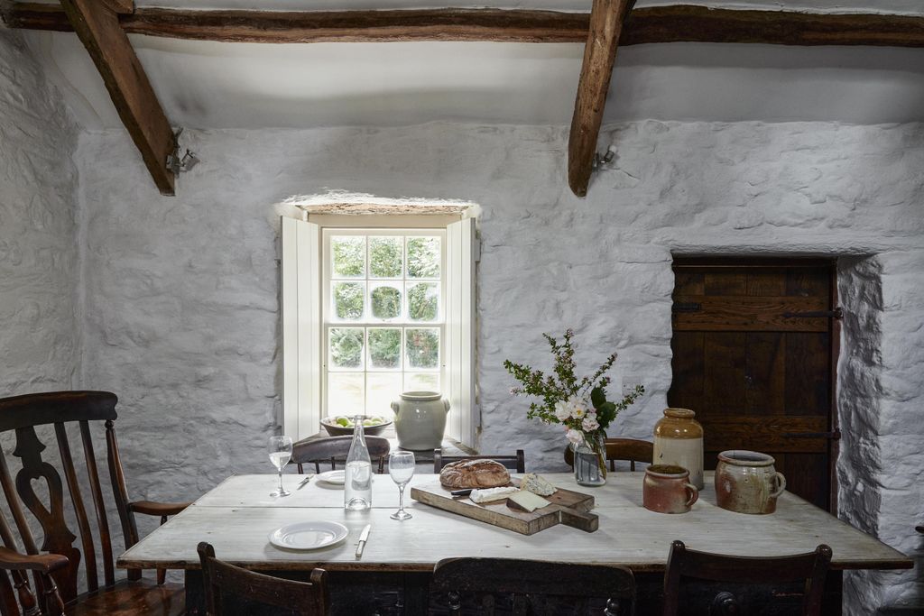 The scrubbed Sycamore kitchen table is surrounded by oak chairs. Dorian explains that Sycamore is a wonderful wood for...