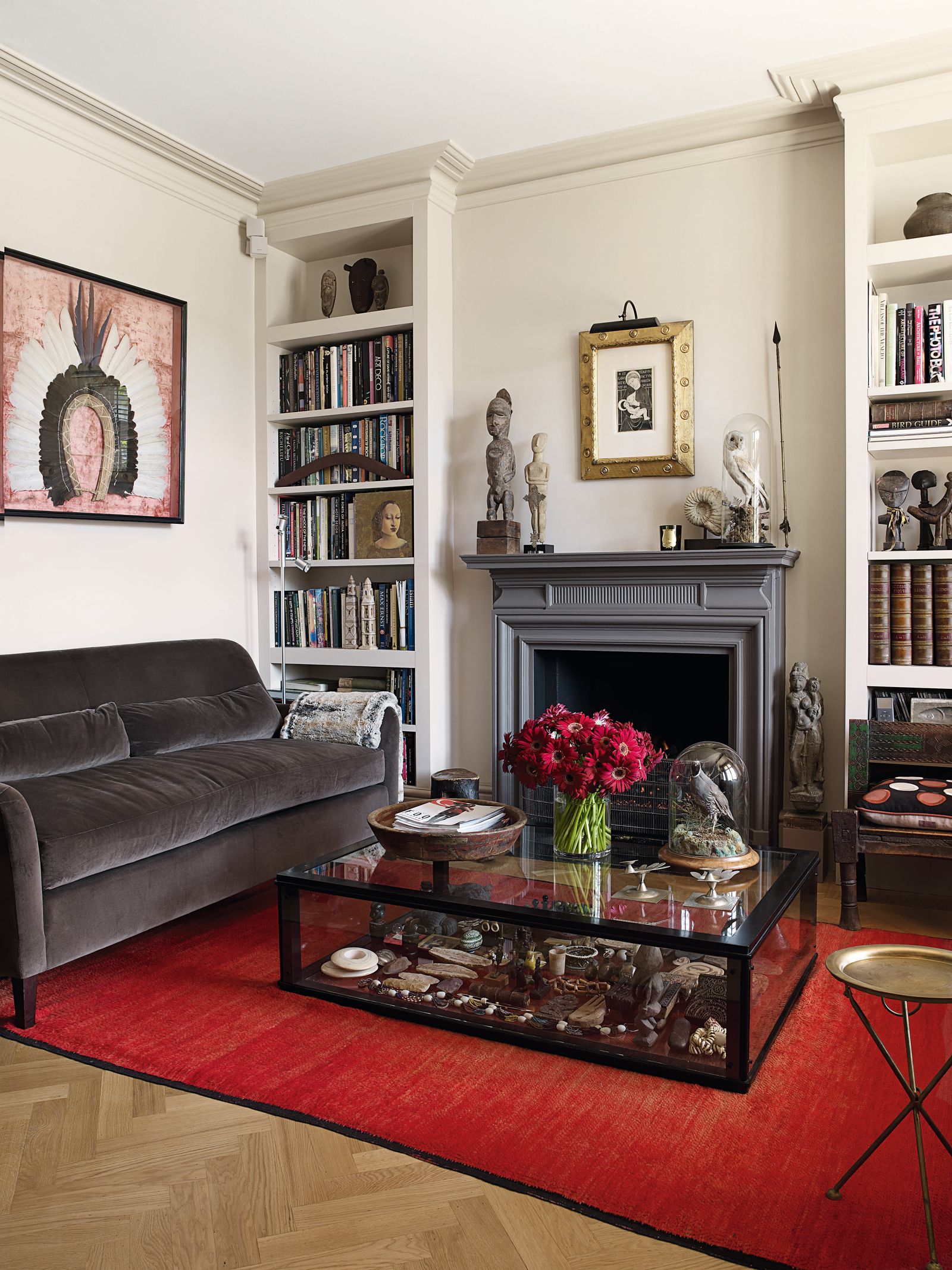 The sitting room has original parquet floors the glass coffee table doubles as a display case for curios.
