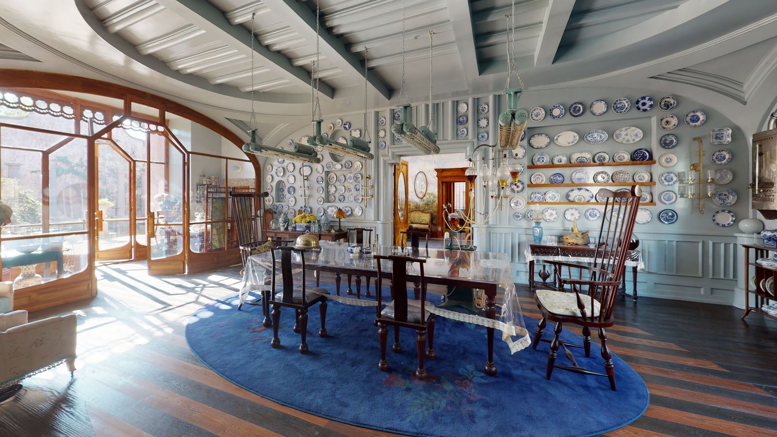 Absurd elements like the extra large dining chairs and overhead heat lamps blend with regular British decorating motifs...