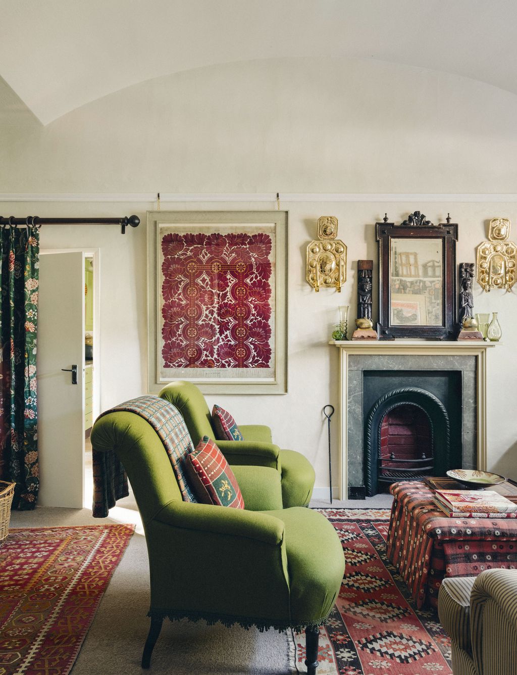 Two vintage French armchairs are upholstered in Linwoods ‘Lana wool in a favourite shade of green. Brass wall sconces...