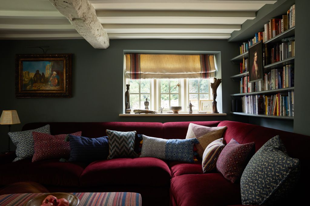 The study doubles as a TV room with a dark colour scheme based around the antique kilim from Susan Deliss on the...