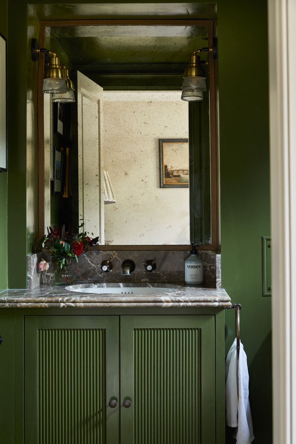 This loo has walls and a ceiling in Farrow  Ball's ‘Bancha with a gloss finish. A bespoke mirror sets off hardware from...