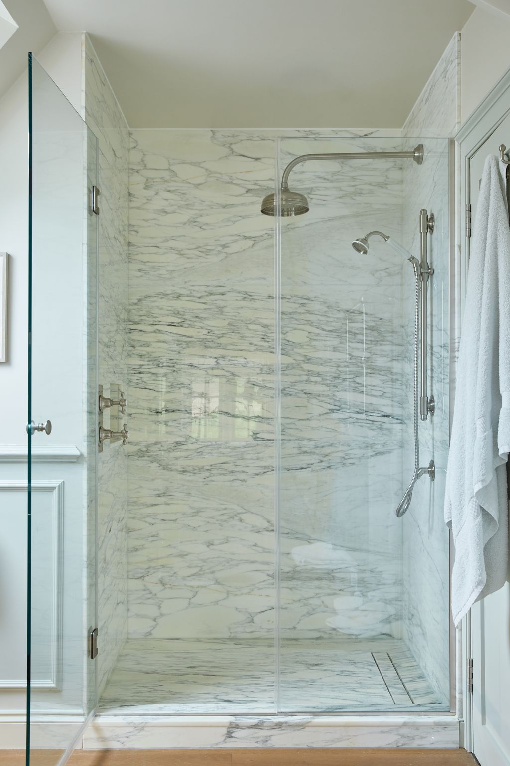 The shower is lined in Arabescato marble with fittings from Drummonds.