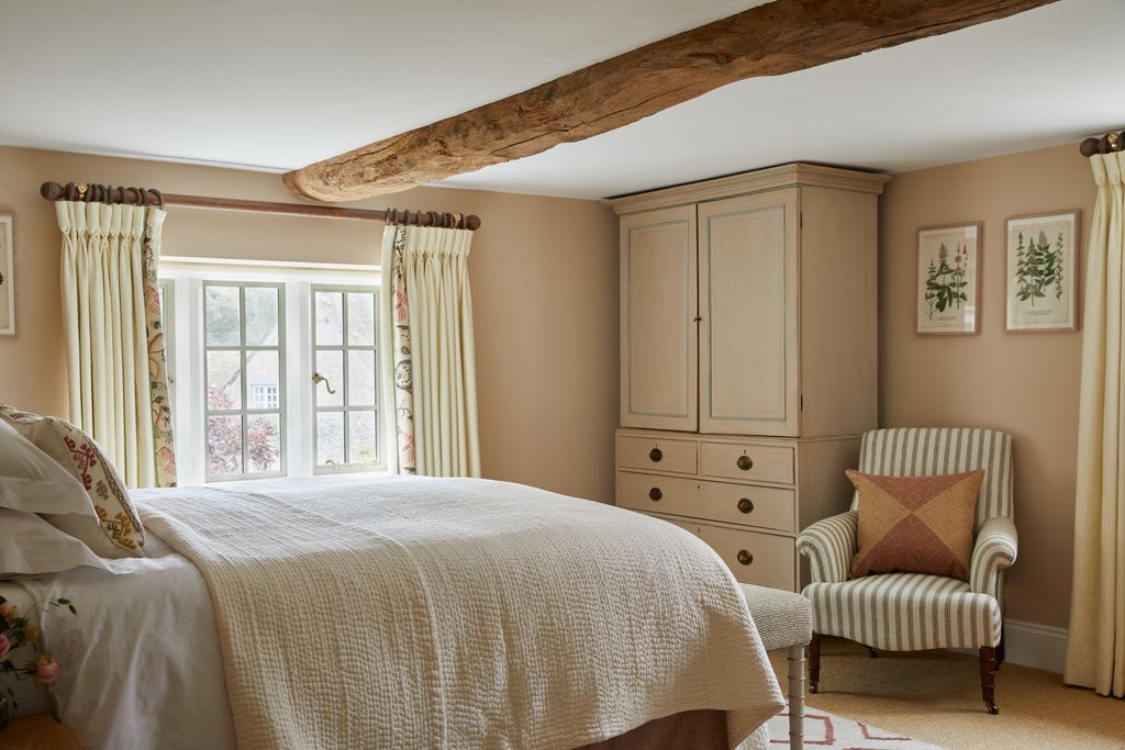 The guest bedroom has walls in Paint and Paper Library's ‘Leather III set off by a natural fibre carpet from and a rug...