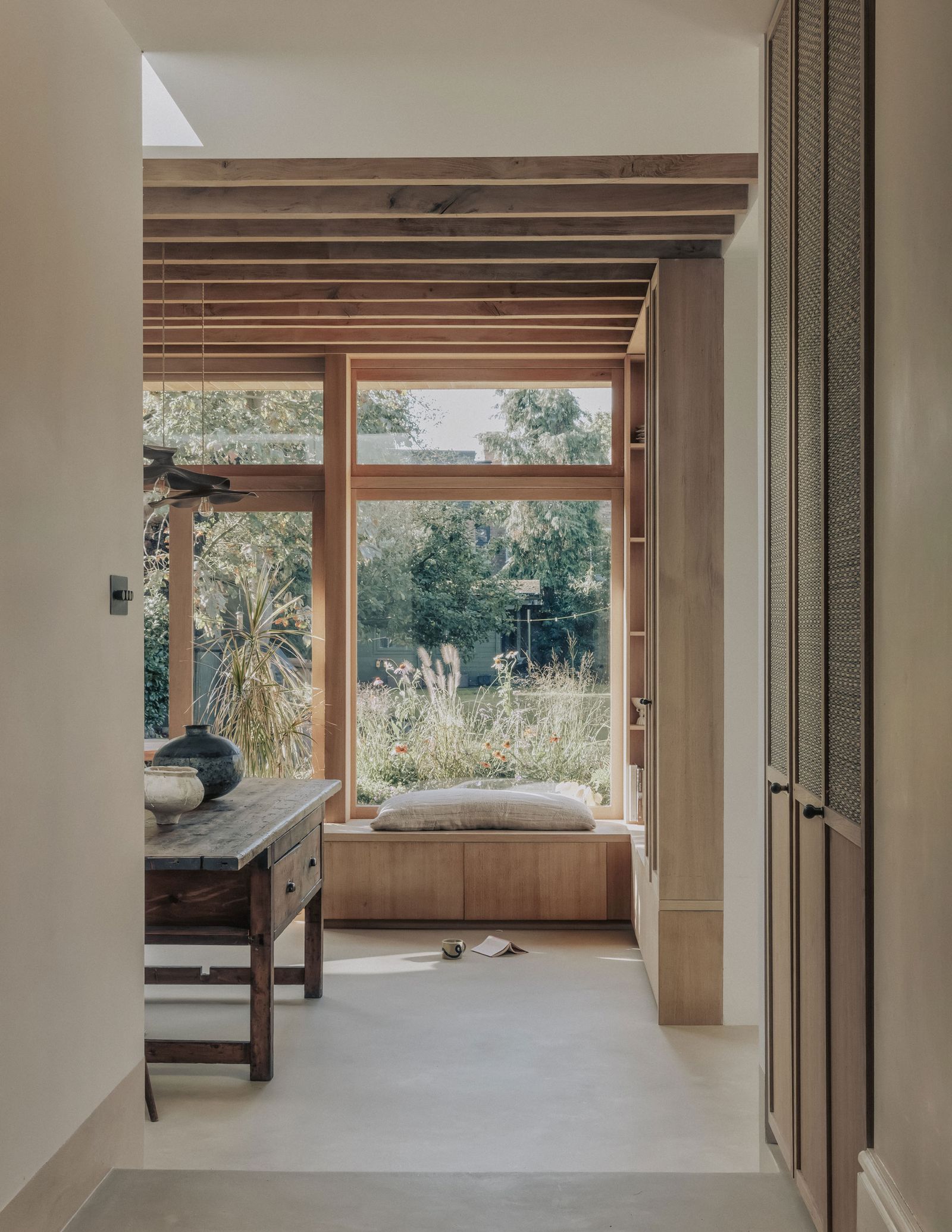 The kitchen looks out onto the garden and has lots of clever storage hidden under seating and built into the walls.