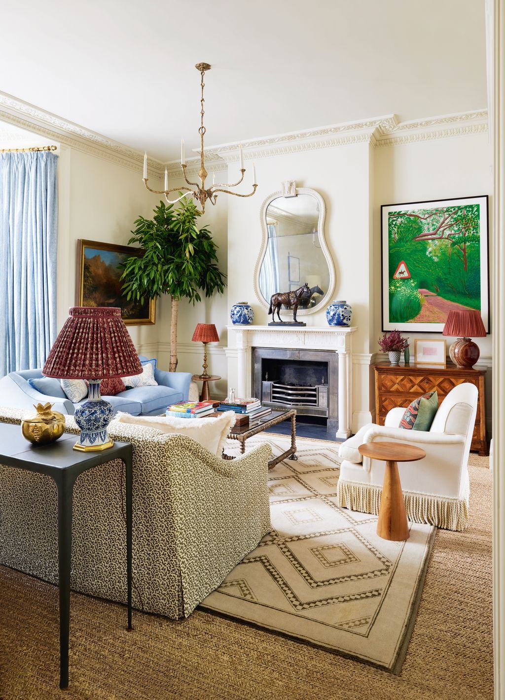 Cox Londons ‘Bronze Mask chandelier a ‘Bucranium mirror from Howe London and a walnut side table from Rose Uniacke...