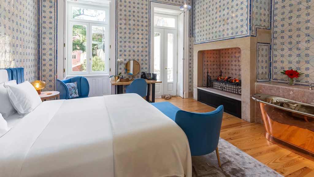 This perfectly pink 19thcentury palace sits looking onto a large and leafy garden a purple jacaranda tree giving shade...