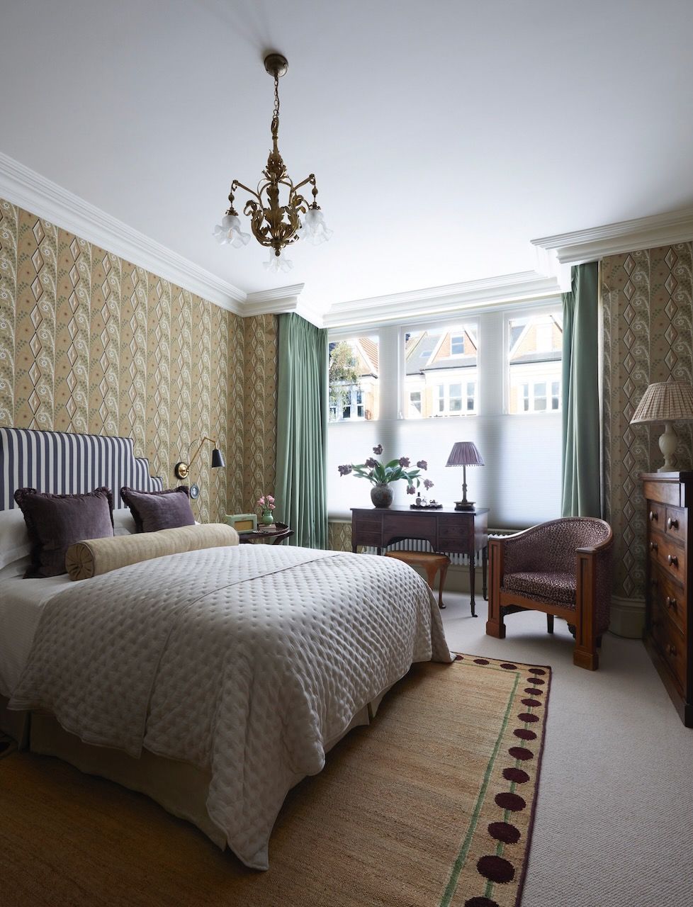 In a flat designed by Laura Stephens the simple addition of an antique table transforms this bay window into a...