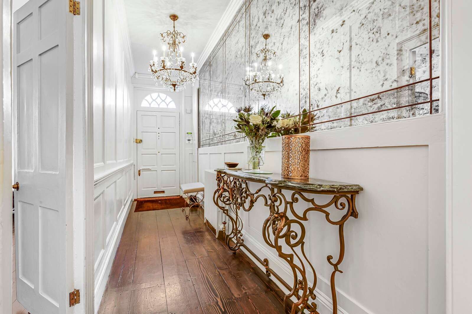 Image may contain Indoors Architecture Building Foyer Lamp Interior Design Plant Home Decor Rug Desk and Furniture