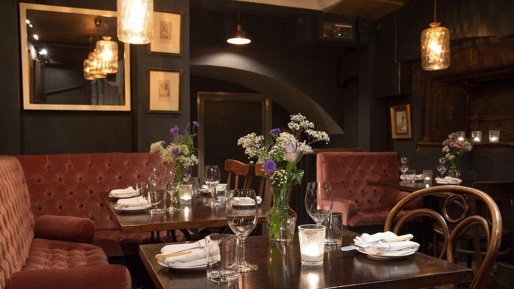 Image may contain Architecture Building Dining Room Dining Table Furniture Indoors Room Table Lamp and Cup