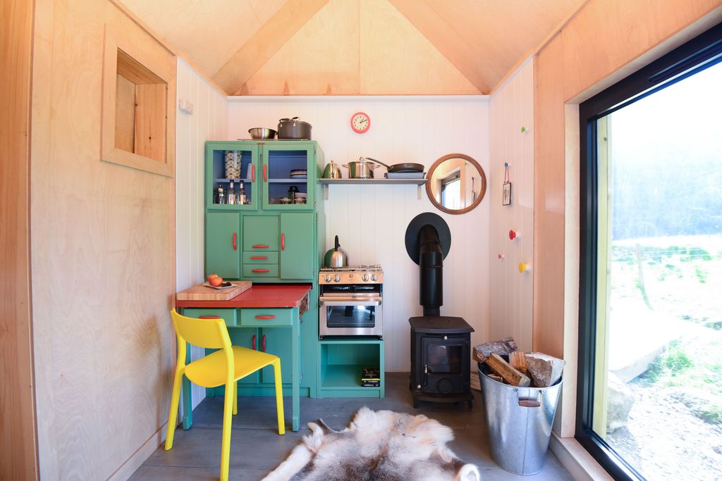 Image may contain Indoors Interior Design Desk Furniture Table Chair Dining Table Kitchen Wood Person and Floor