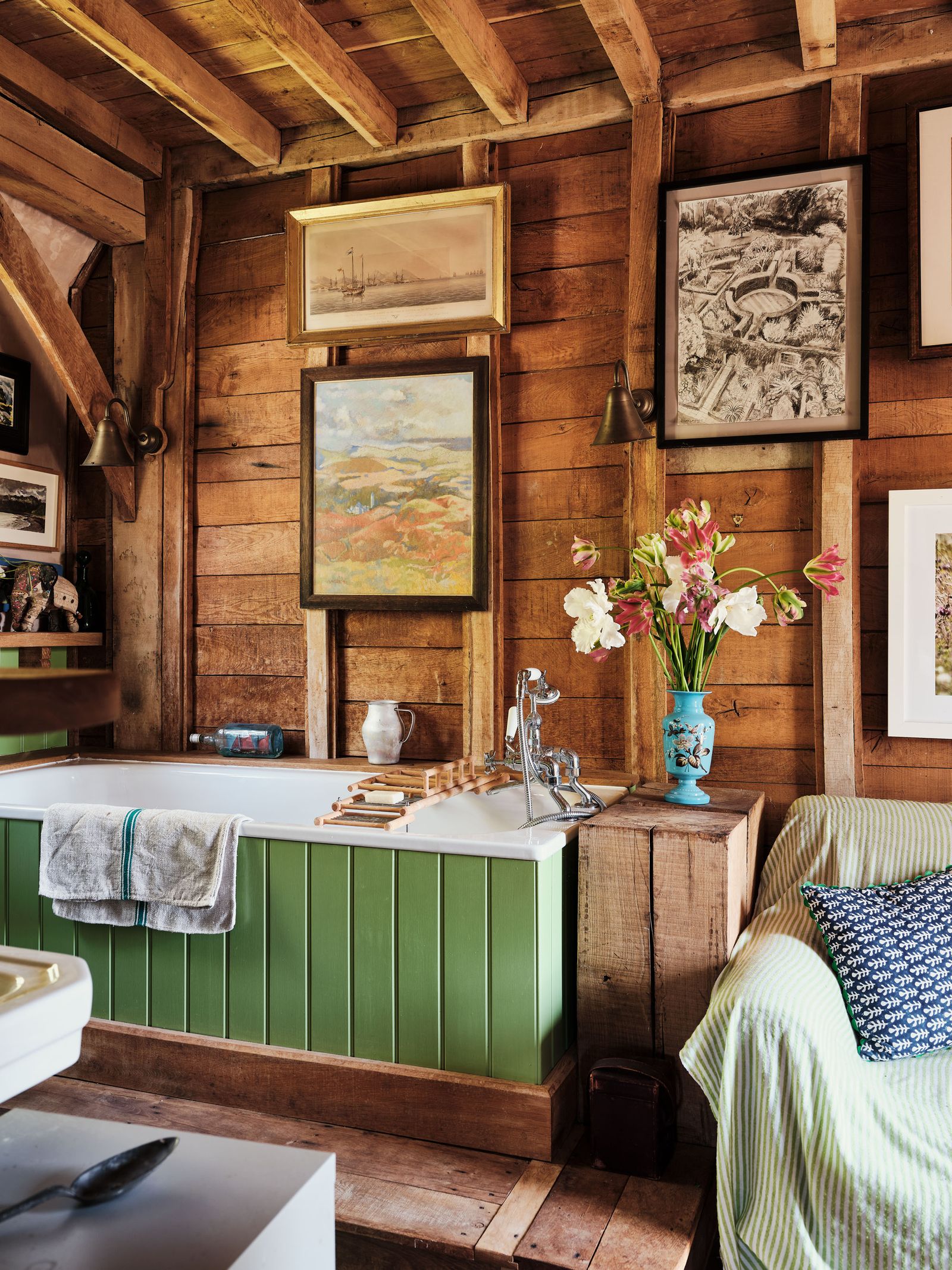 Image may contain Indoors Interior Design Wood Hardwood Stained Wood Cutlery Spoon Art Painting Lamp and Couch