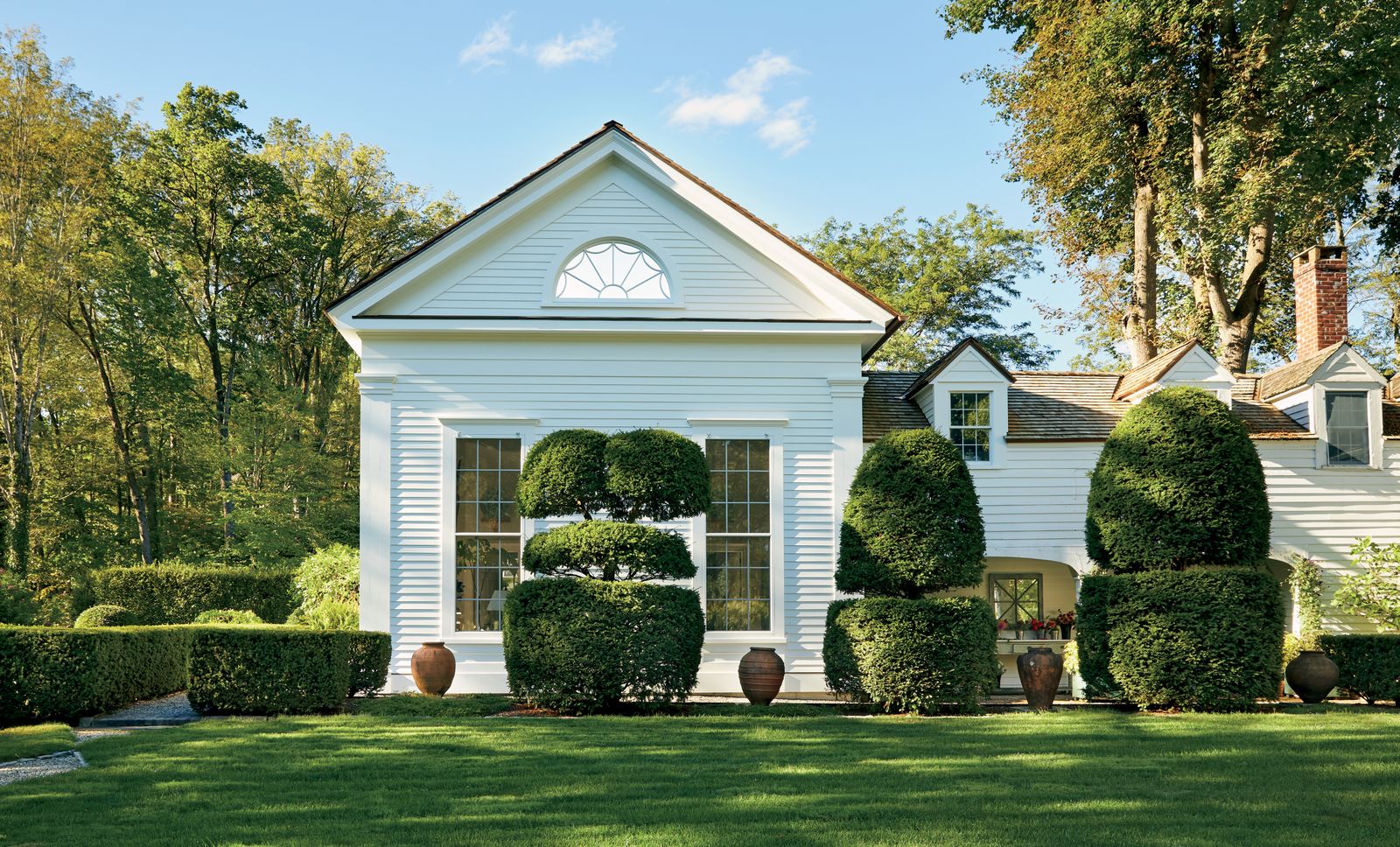 Image may contain Grass Plant Lawn Fence Hedge Architecture Building Housing House Tree and Portico