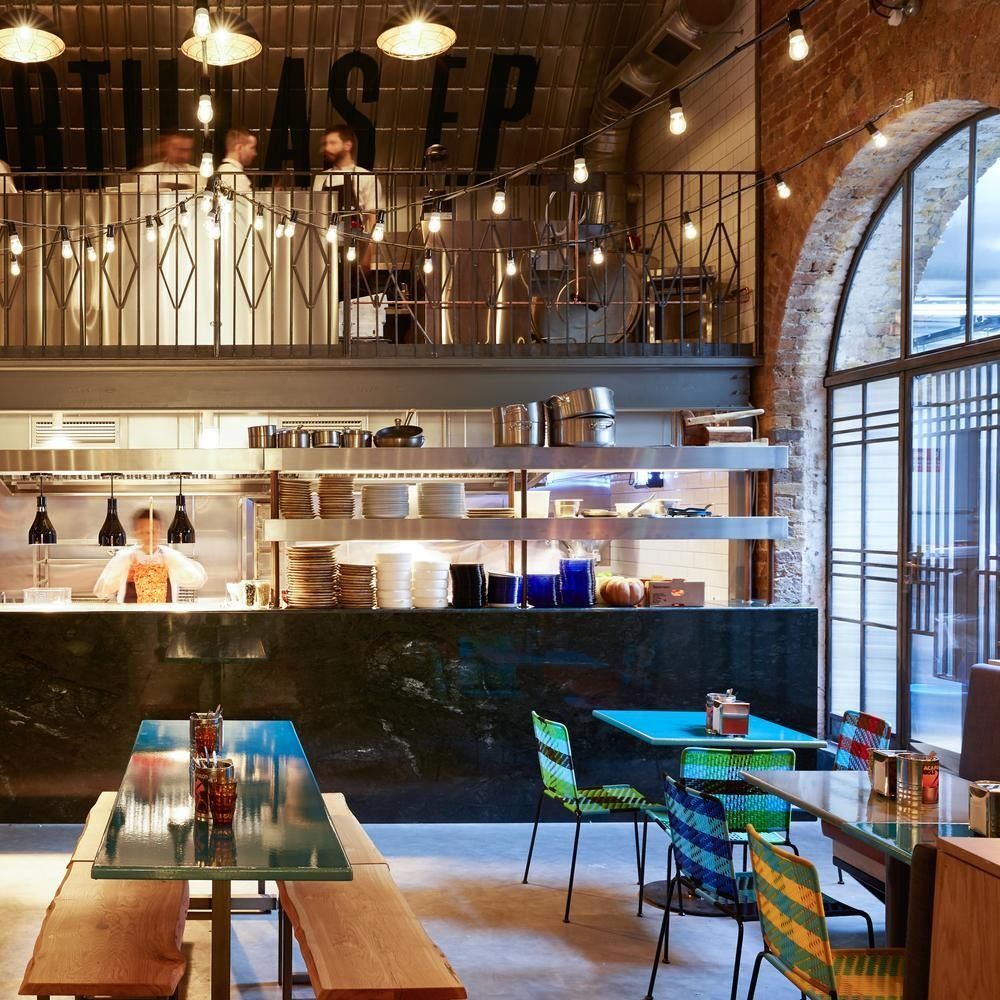 Image may contain Indoors Restaurant Cafeteria Desk Furniture Table Chair Lamp Cup Person Cafe and Dining Table