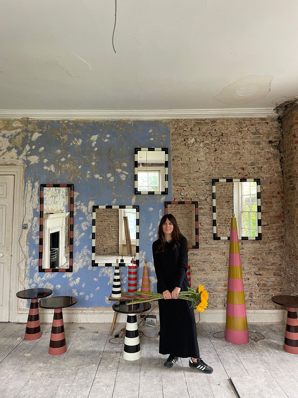 Image may contain Desk Furniture Table Adult Person Clothing Footwear Shoe Indoors Interior Design and Floor