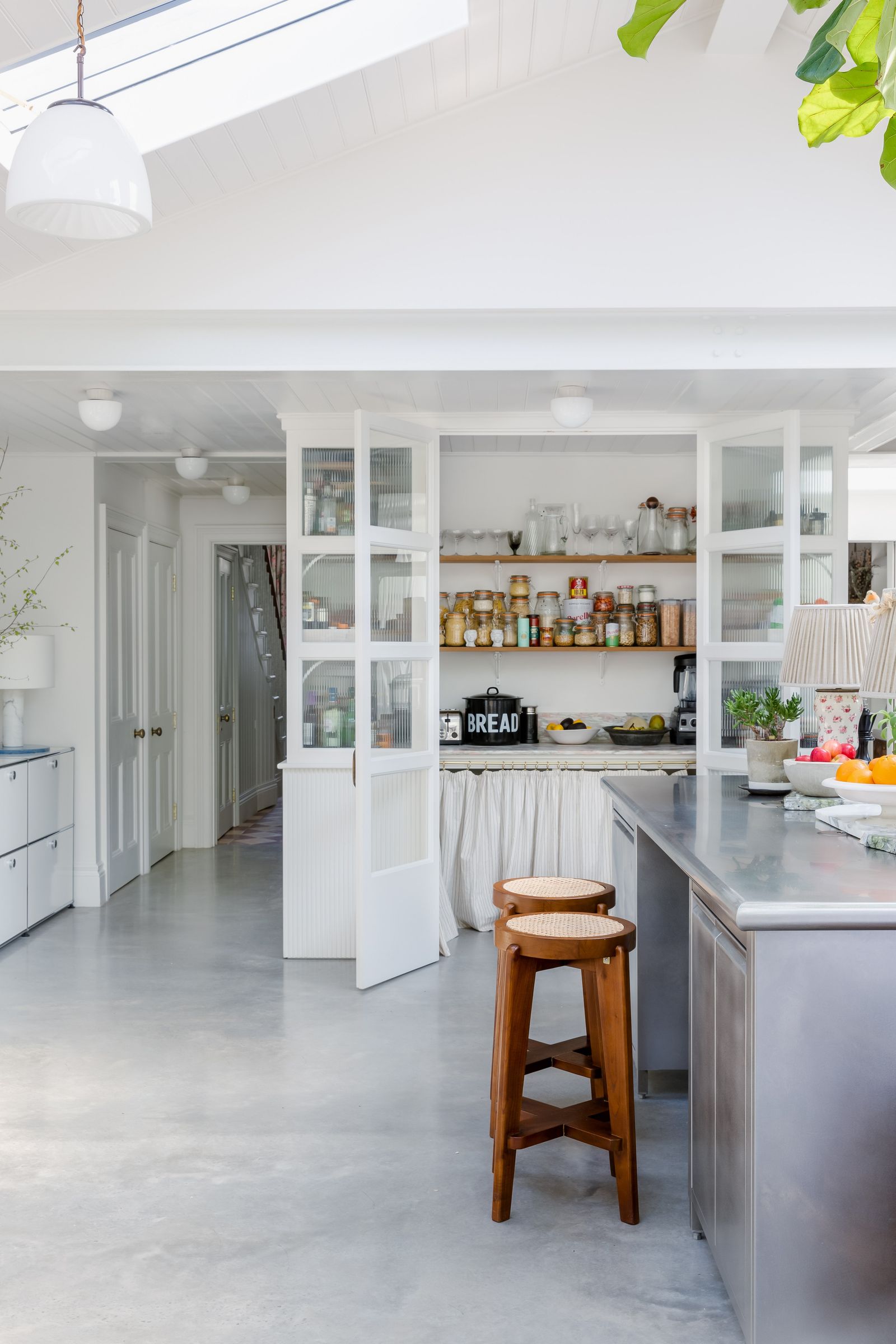 Image may contain Shelf Indoors Interior Design Plant Lamp Floor Kitchen Bar Stool Furniture and Pantry