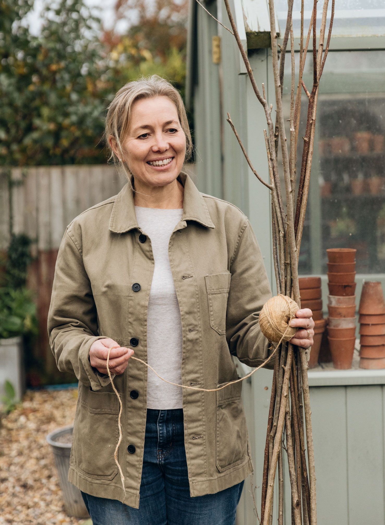 Image may contain Blonde Hair Person Face Happy Head Smile Clothing Coat Adult Jacket Pants and Blazer