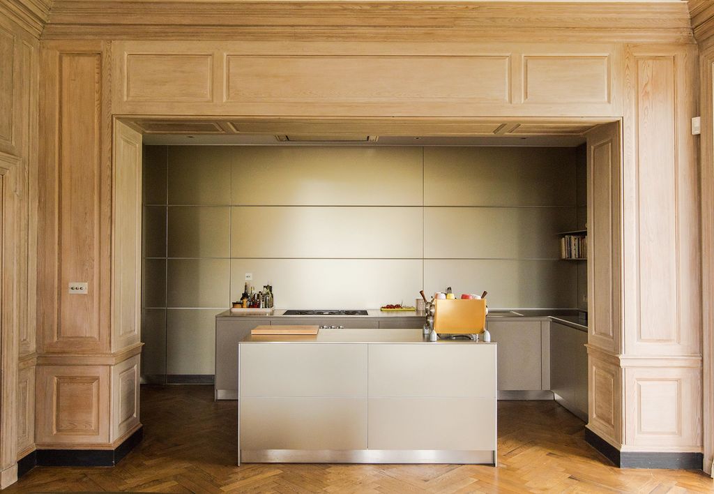 Image may contain Indoors Interior Design Kitchen Wood Panels Wood Floor and Cooktop