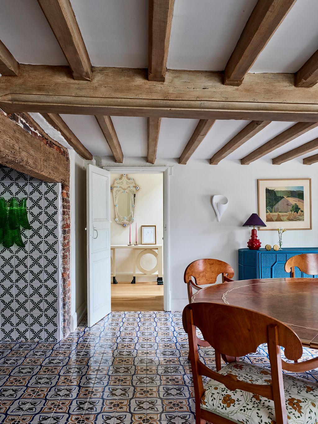 Image may contain Indoors Interior Design Floor Lamp Chair Furniture Wood Art Painting Flooring and Home Decor