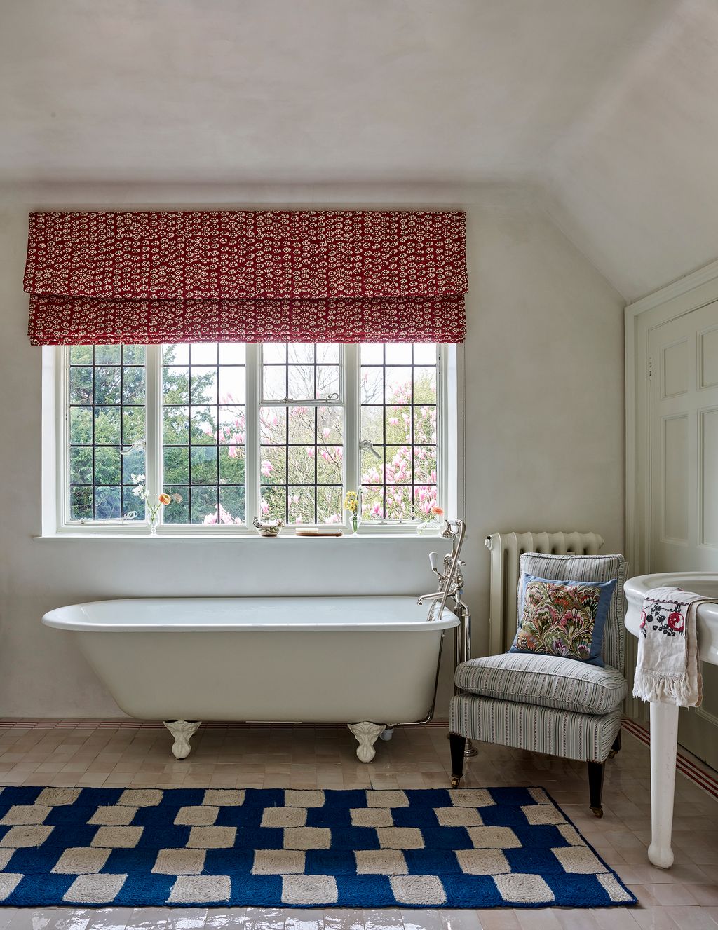 Image may contain Home Decor Rug Chair Furniture Bathing Bathtub Person Tub and Window