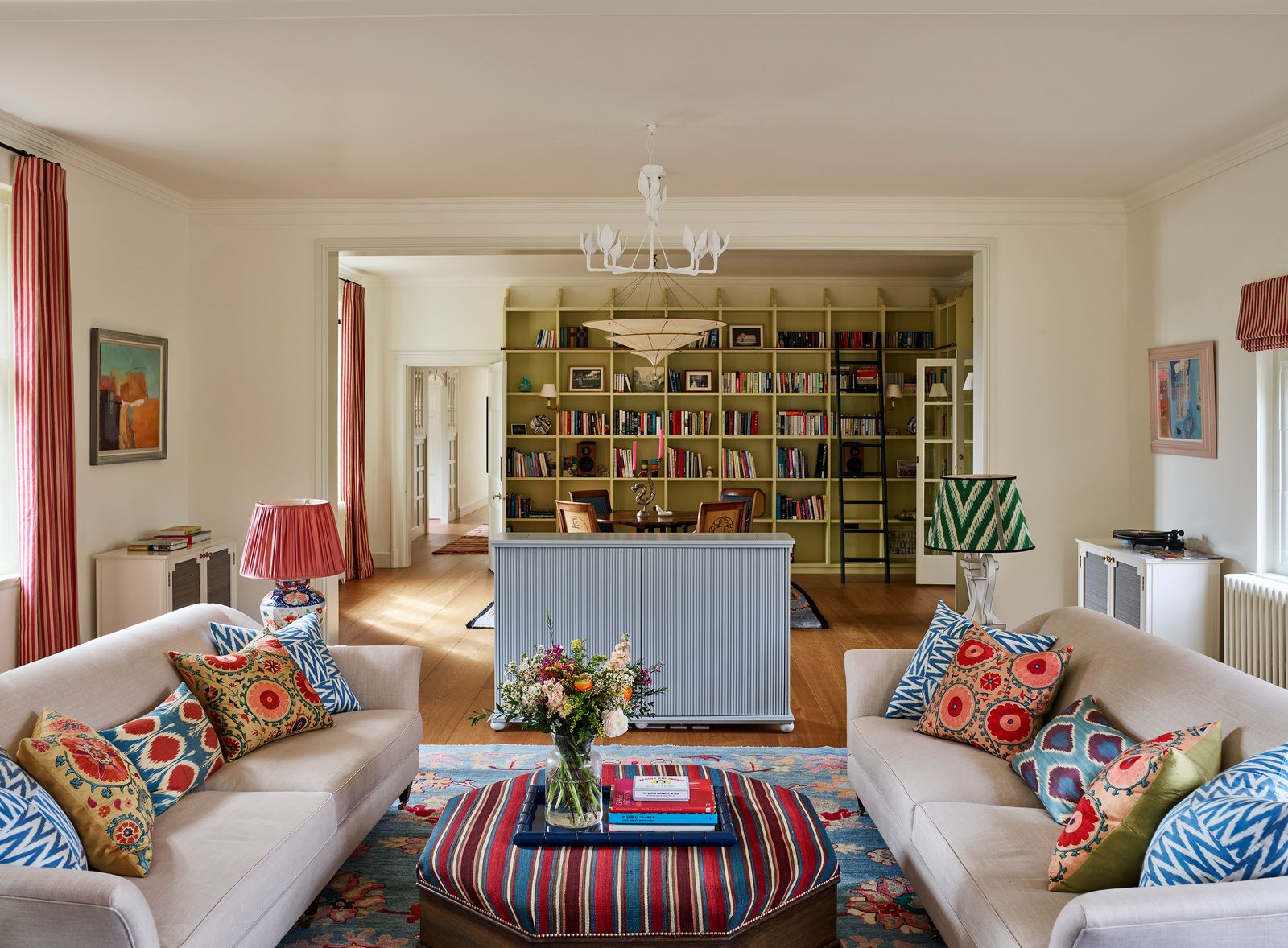 Image may contain Home Decor Lamp Couch Furniture Architecture Building Indoors Living Room Room Art and Painting