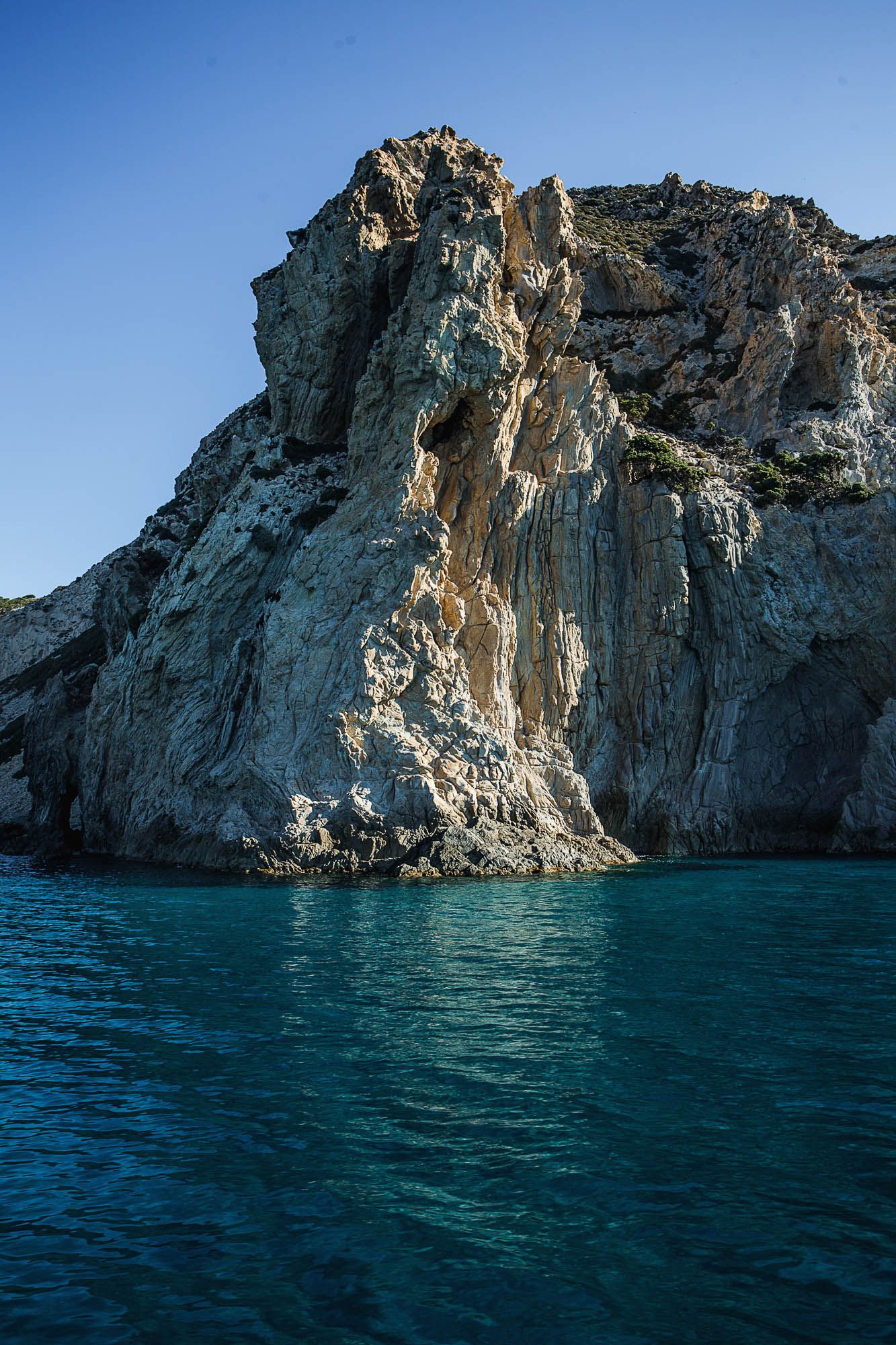 Image may contain Rock Cliff Nature Outdoors Lagoon Lake Water Sea Promontory Scenery Land Shoreline and Coast