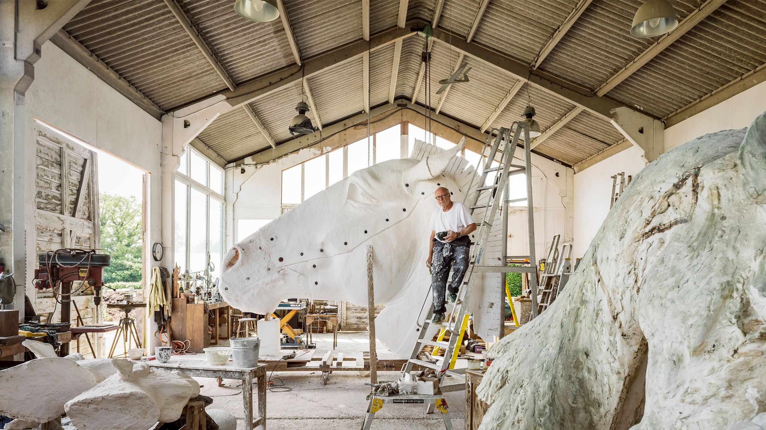 Image may contain Architecture Building Factory Person Manufacturing Lamp Workshop Cup Desk Furniture and Table