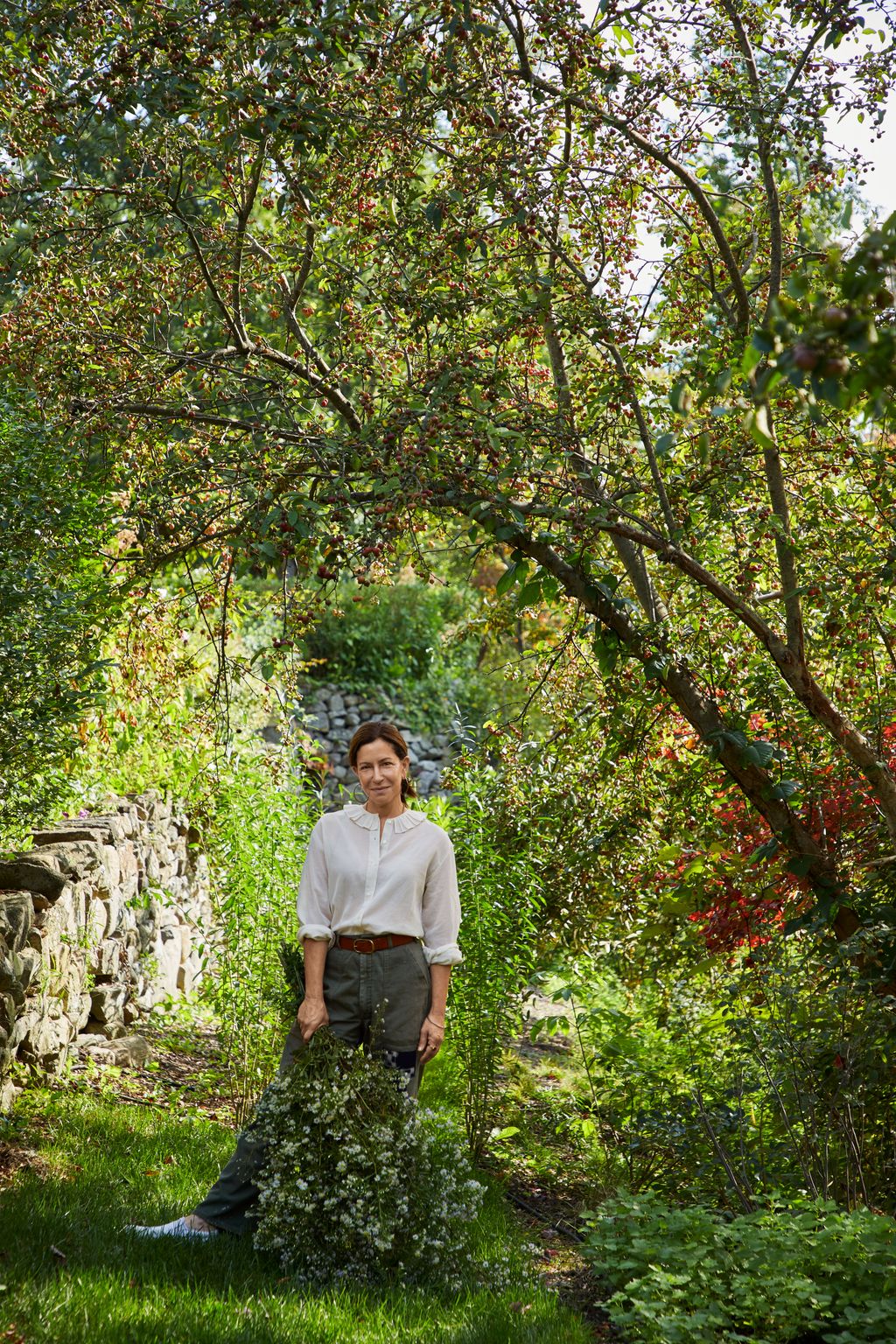 Image may contain Clothing Pants Plant Vegetation Person Standing Accessories Belt Land Nature Outdoors and Tree