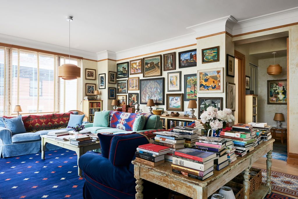 Image may contain Home Decor Lamp Couch Furniture Art Painting Desk Table Architecture Building and Indoors