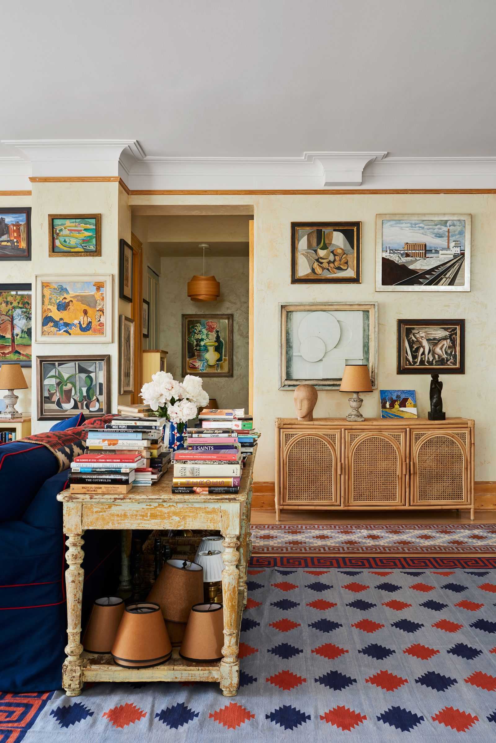 Image may contain Lamp Home Decor Indoors Interior Design Art Painting Person Furniture Rug Desk and Table