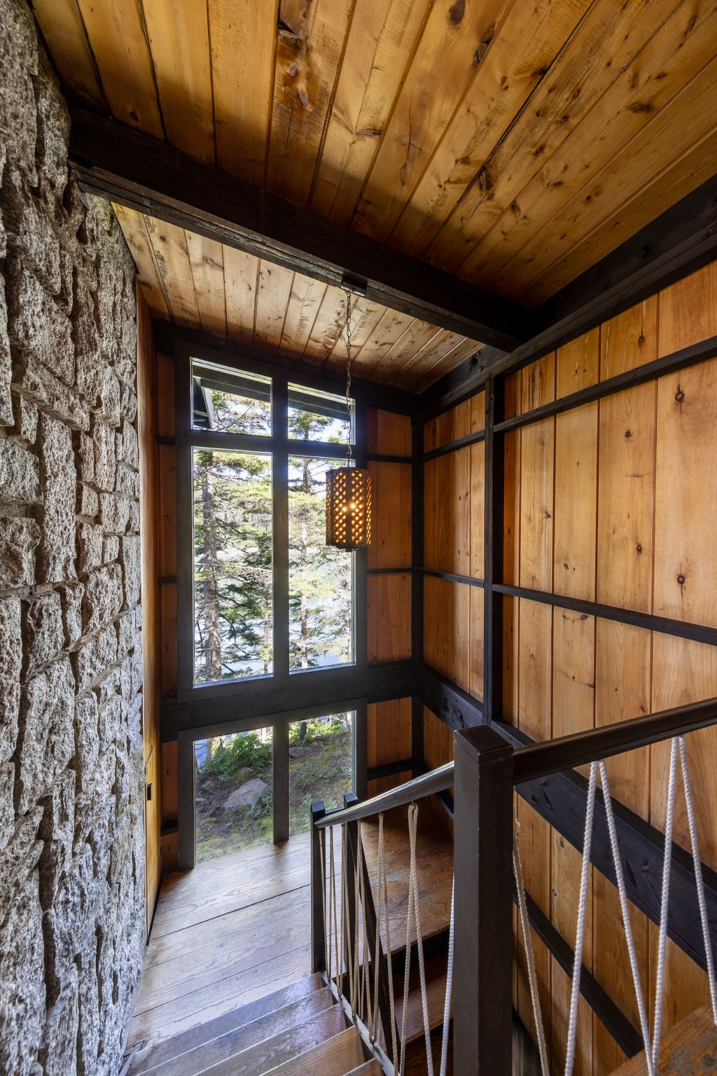 Image may contain Indoors Interior Design Wood Lamp Hardwood Architecture Building House Housing and Staircase