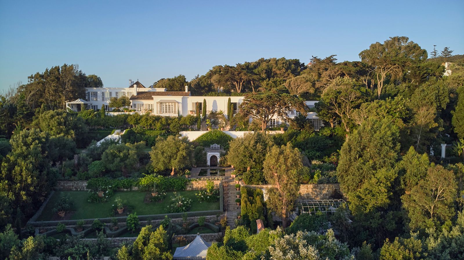 Image may contain Architecture Building House Housing Villa Plant Vegetation Outdoors Tree Land and Nature