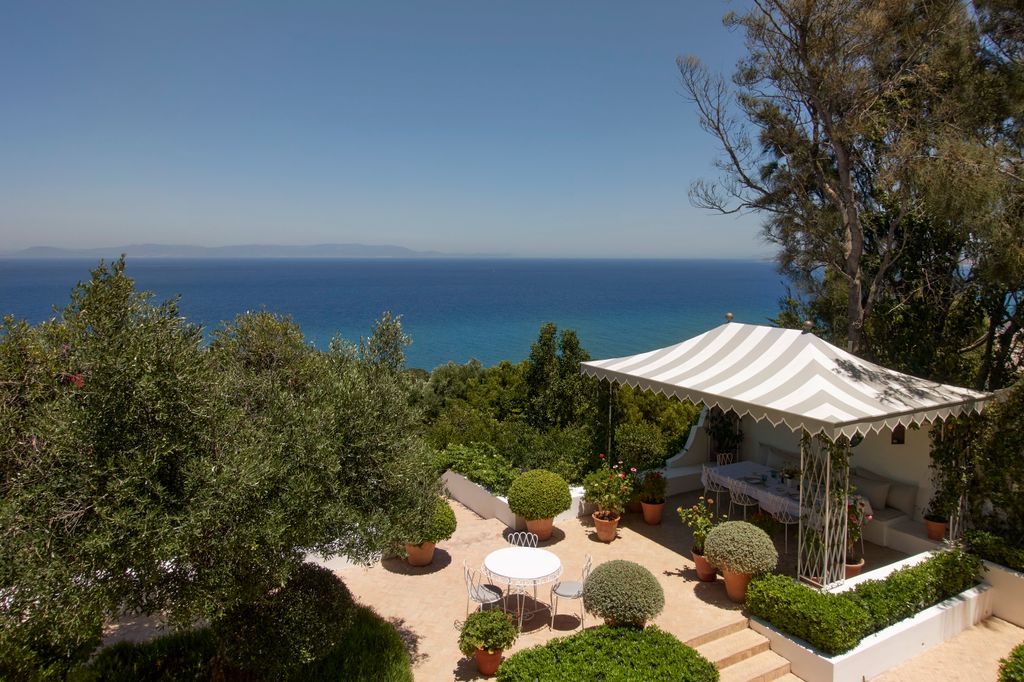 Image may contain Nature Outdoors Scenery Plant Architecture Building House Housing Villa Desk and Furniture