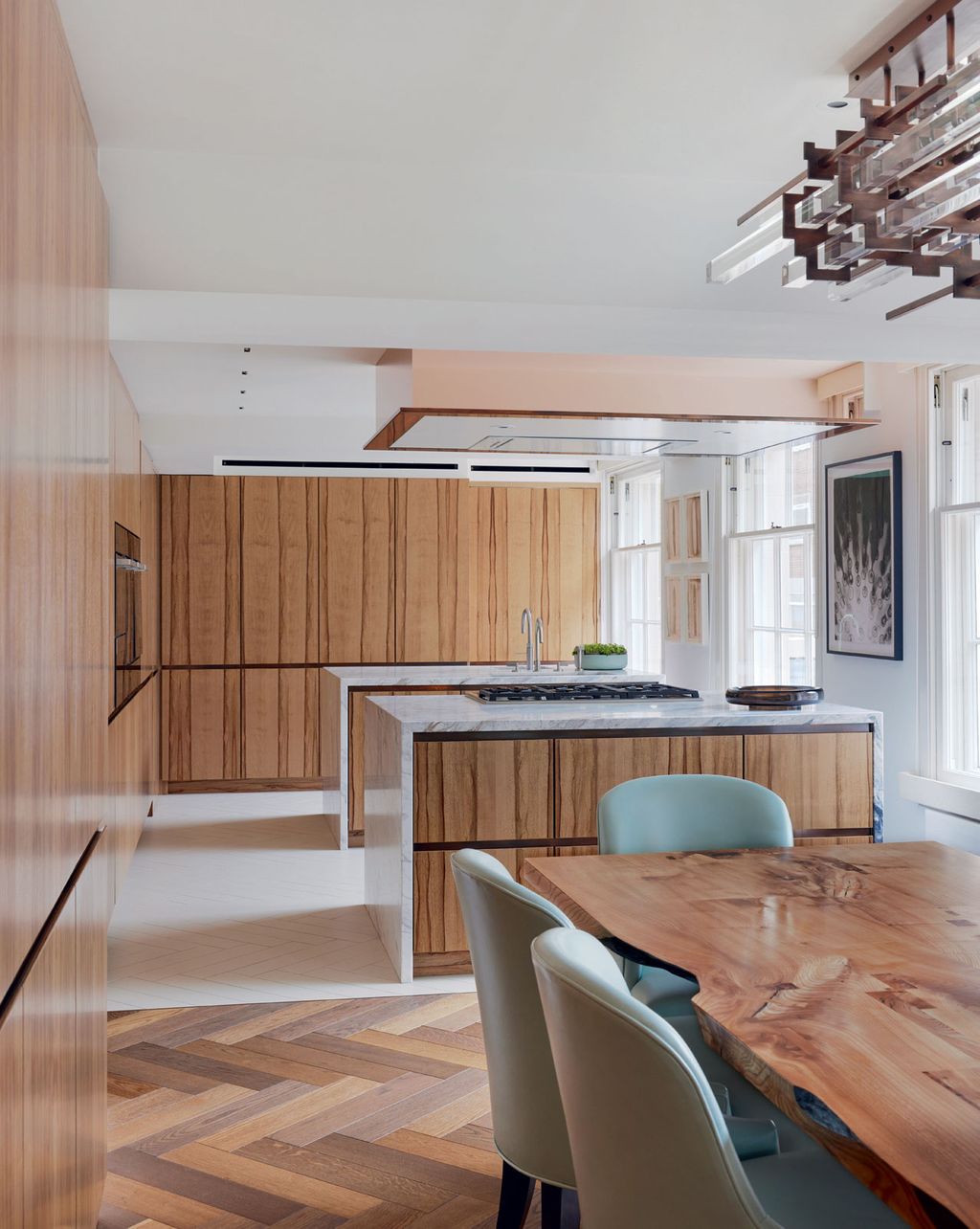 Image may contain Indoors Interior Design Wood Kitchen Chair Furniture Art Painting Wood Panels Cooktop and Sink