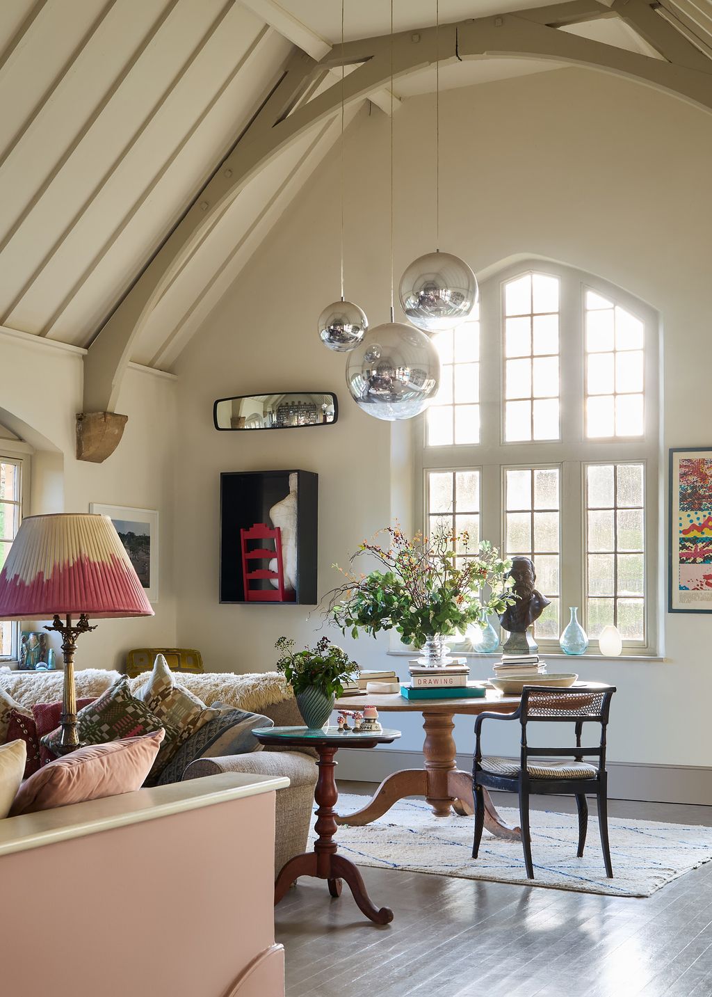 Image may contain Chair Furniture Lamp Desk Table Home Decor Art Painting Person Rug Window Couch and Indoors