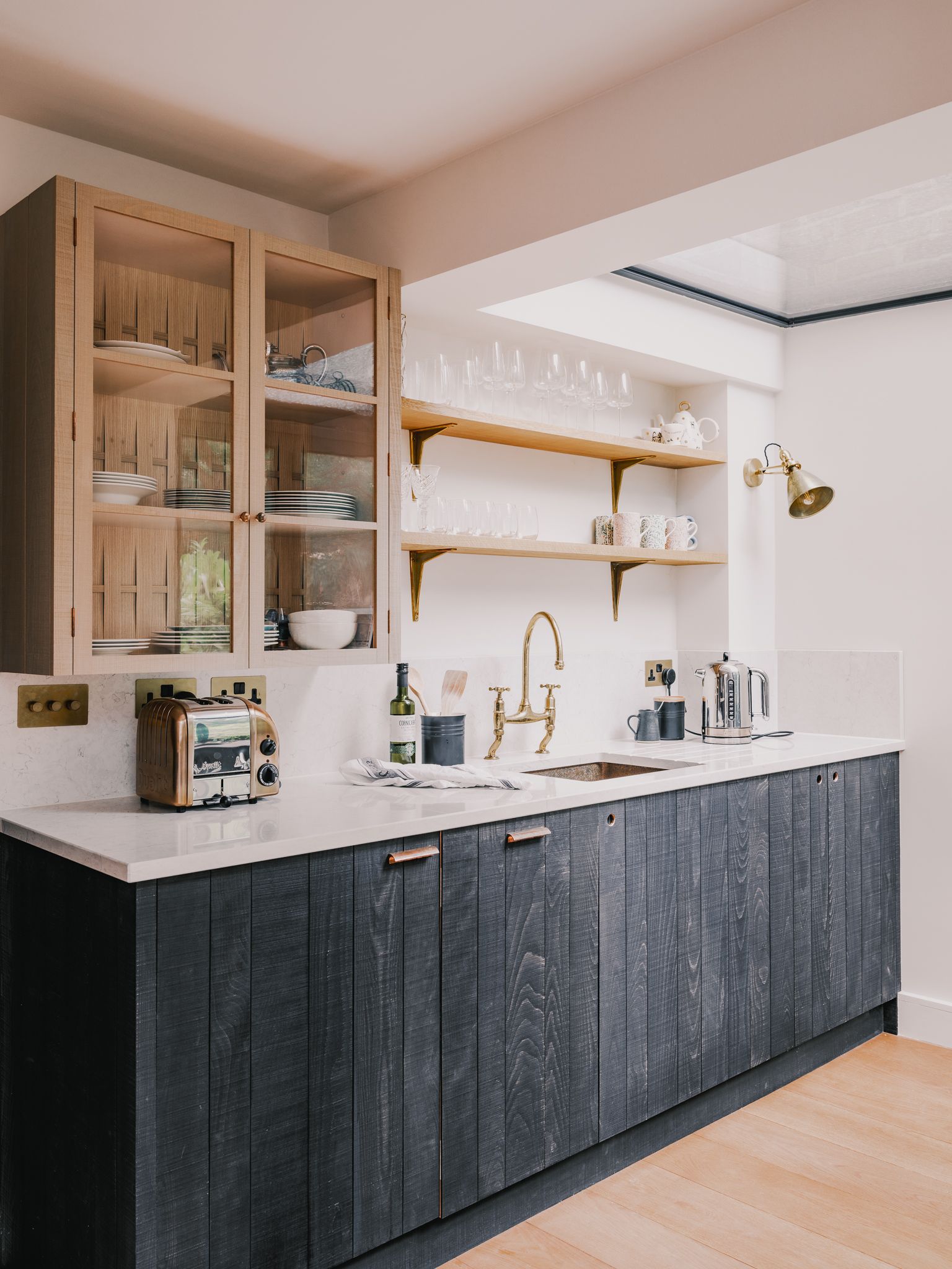 Image may contain Indoors Interior Design Lamp Kitchen Sink Sink Faucet Cabinet Furniture Cup Closet and Cupboard