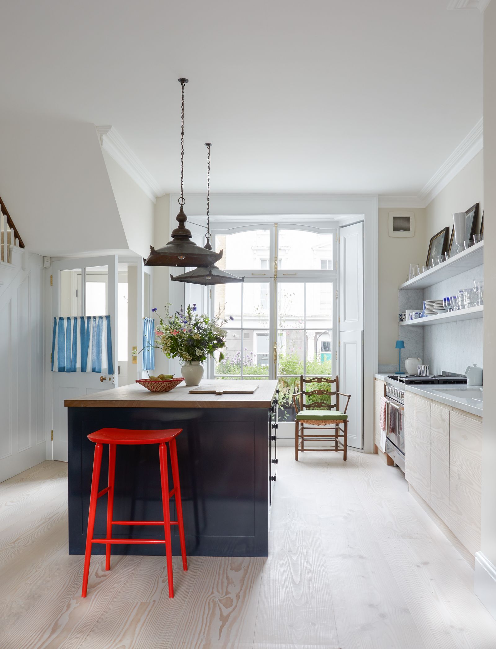 Image may contain Indoors Interior Design Chair Furniture Kitchen Lamp Bar Stool Cup Table Cooktop and Window