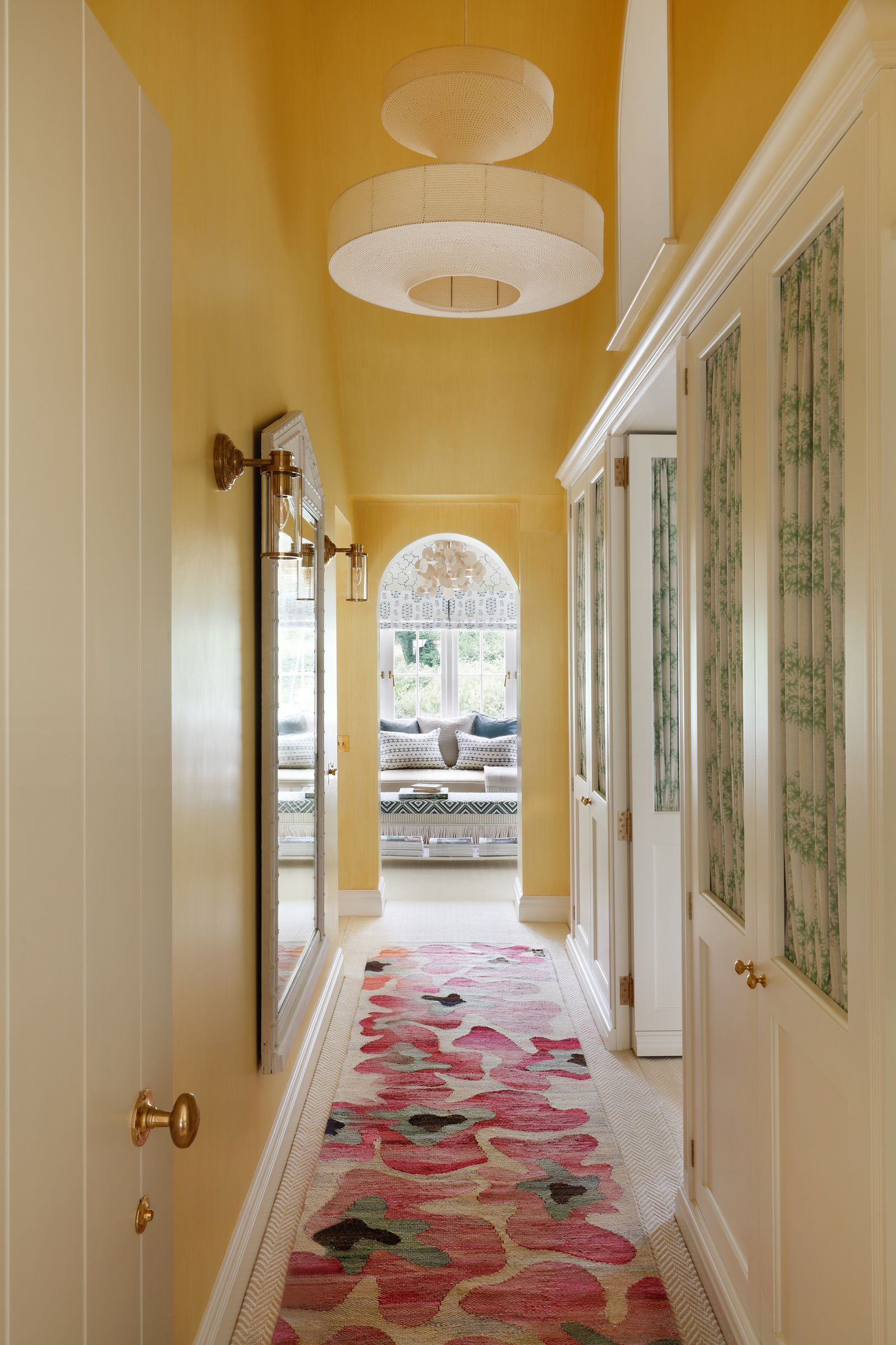 Image may contain Indoors Home Decor Rug Hallway and Lamp