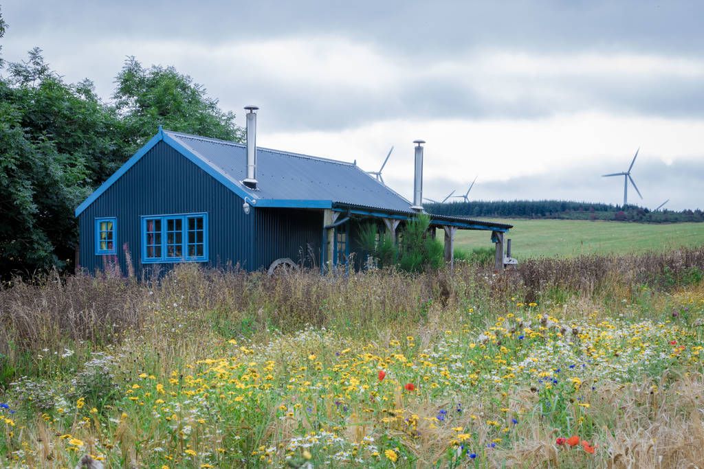Image may contain Architecture Building Outdoors Shelter Grass Plant Nature Countryside Cottage House and Housing