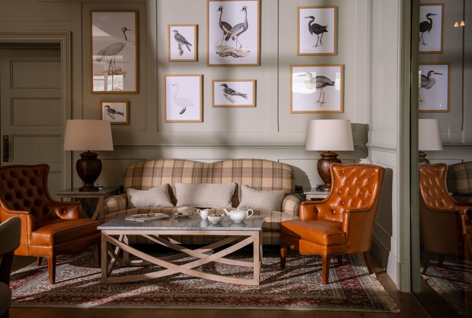 Image may contain Home Decor Lamp Chair Furniture Table Couch Coffee Table Architecture Building and Indoors