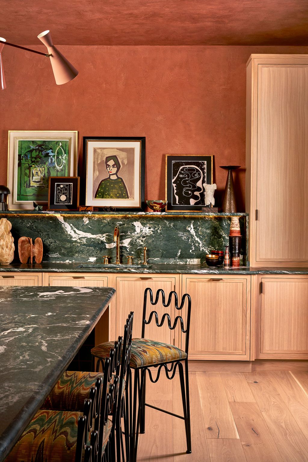 Image may contain Indoors Interior Design Wood Art Painting Lamp Chair Furniture Person Kitchen Floor and Sink