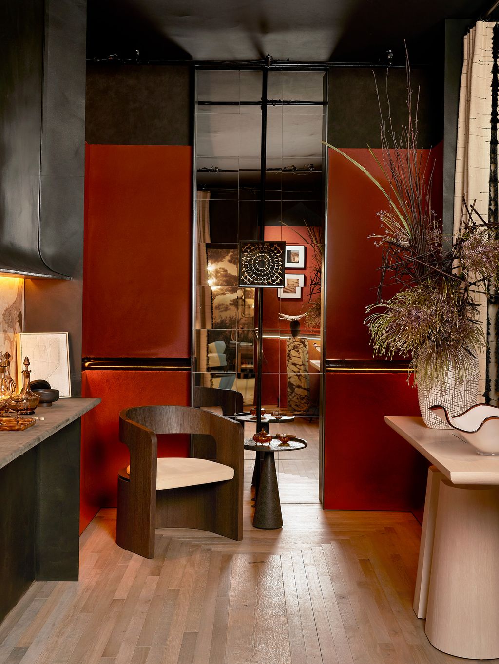 Image may contain Indoors Interior Design Floor Wood Flooring Chair Furniture Art Painting Desk Table and Lamp