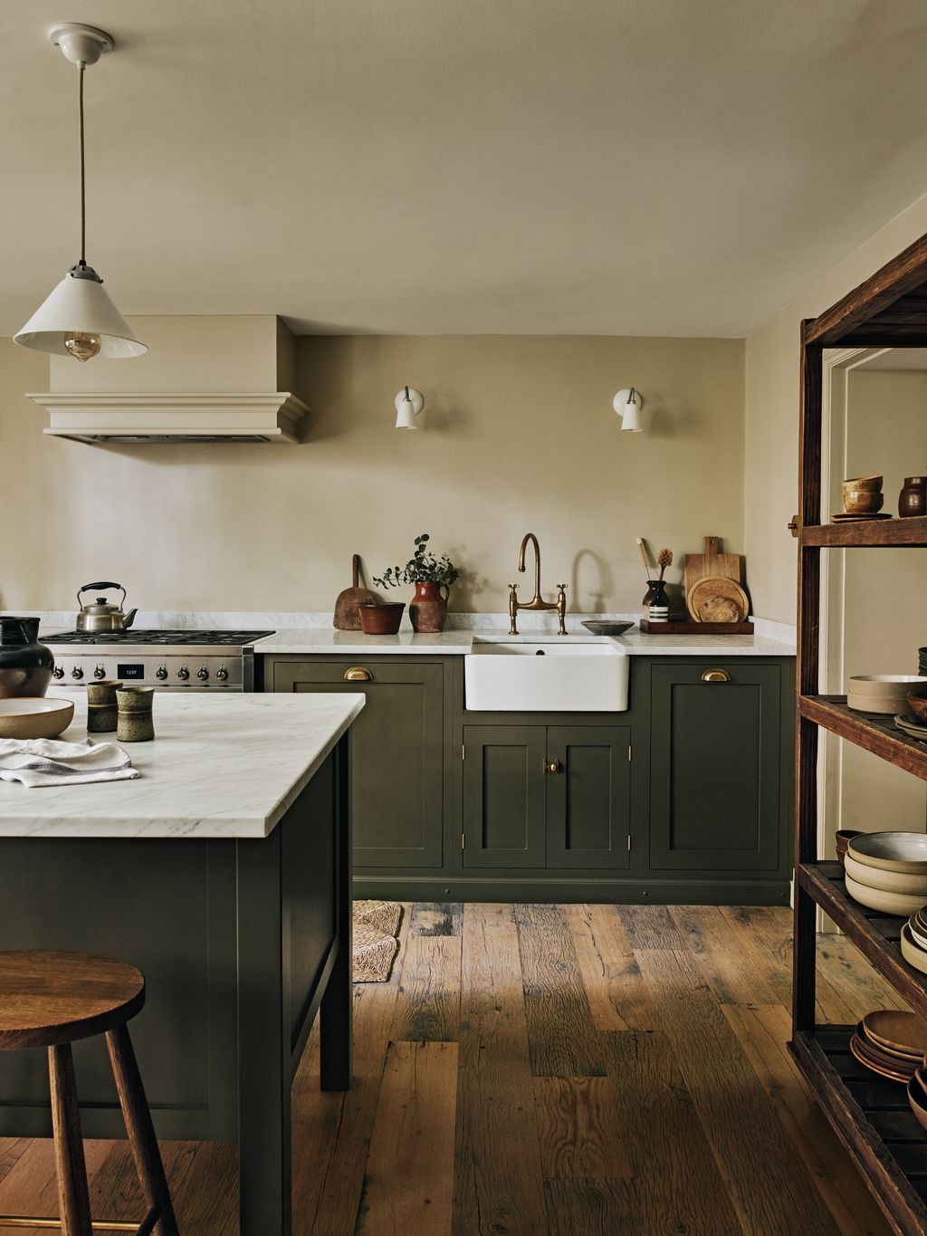 Image may contain Indoors Interior Design Kitchen Kitchen Island Sink Lamp and Sink Faucet