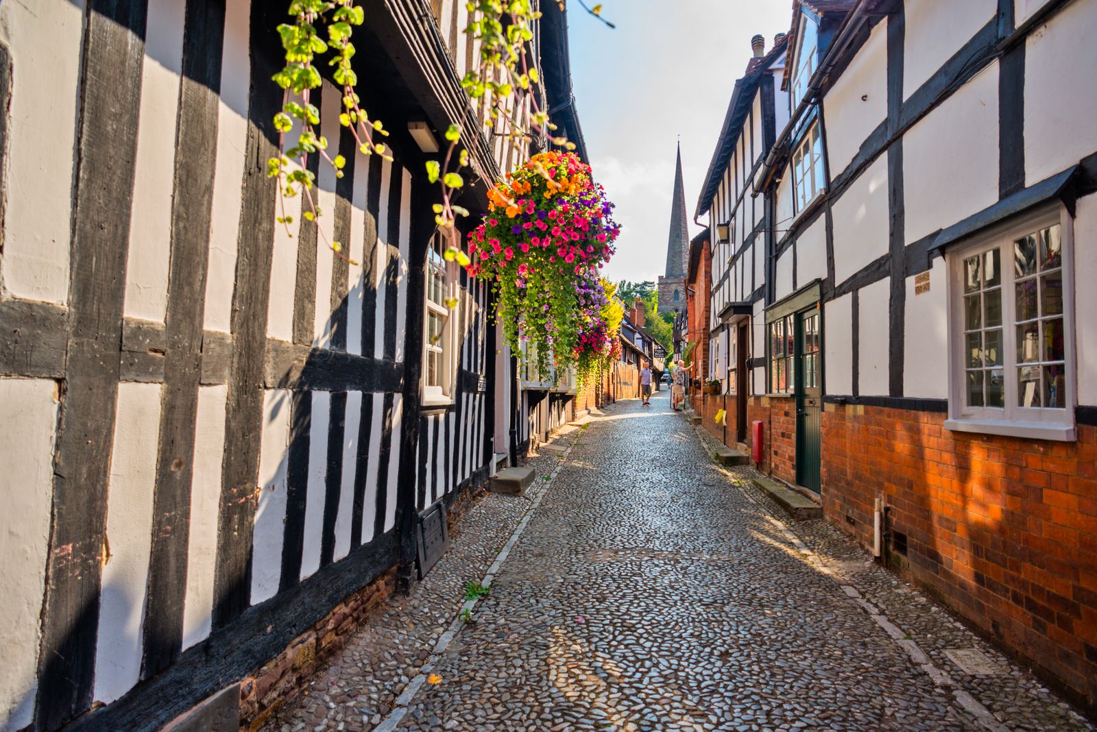 Image may contain City Road Street Urban Alley Path Person Architecture Building Housing Neighborhood and House