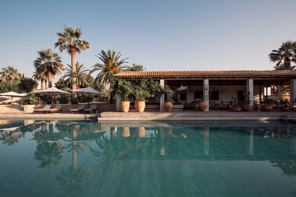 Image may contain Architecture Building House Housing Villa Pool Water Hotel Resort Swimming Pool and Chair